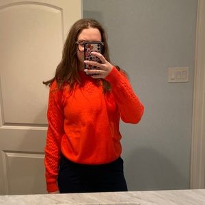 Bright orange sweater with scallop detailing!